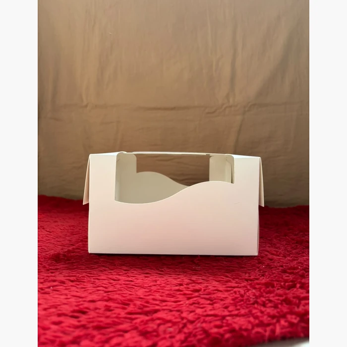 A carrier box with a cut-out handle, seen from the side