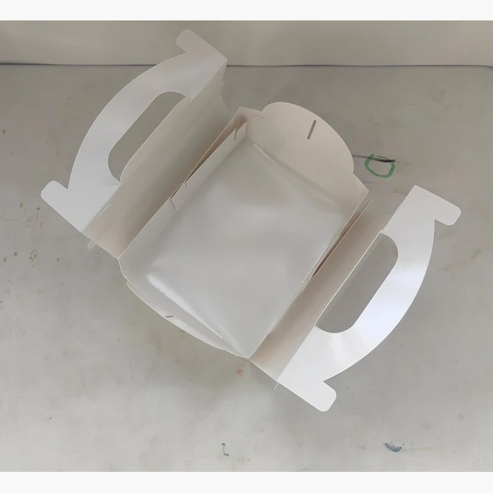 The same cake box seen from above with its handle panels open