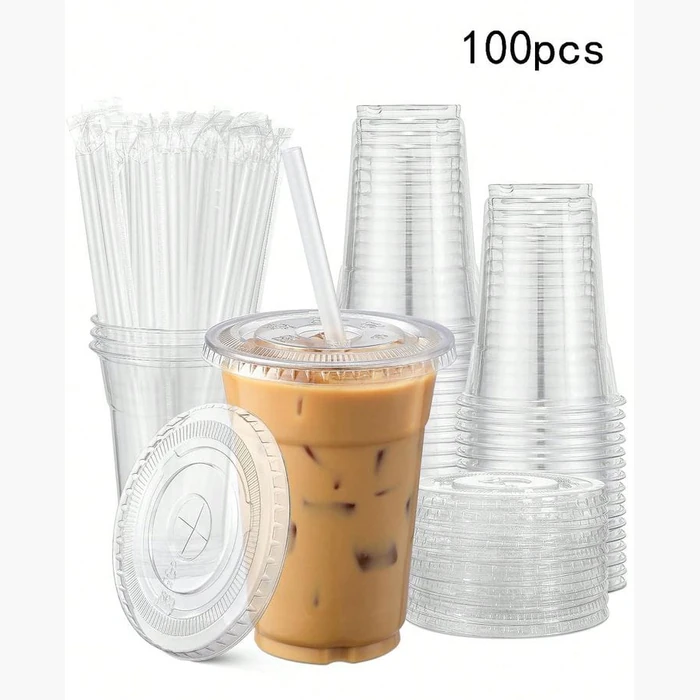 An iced drink cup, dome lid and straw shown together